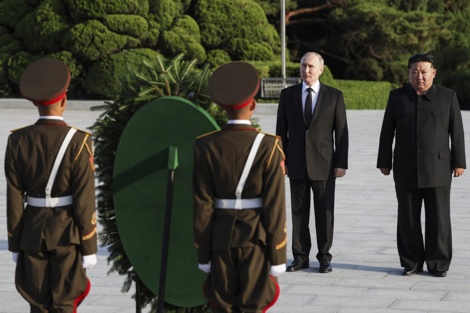 Russian President Vladimir Putin, second right, and North Korea's leader Kim Jong Un attend a wreath-laying ceremony at the Liberation Monument in Pyongyang, North Korea, on Wednesday, June 19, 2024. (Gavriil Grigorov, Sputnik, Kremlin Pool Photo via AP)