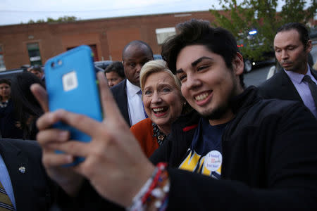Hillary Clinton poses for a picture with supporters at supporters outside of an early voting center Greensboro, North Carolina. REUTERS/Carlos Barria