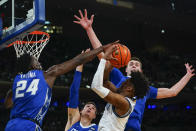 Creighton's Arthur Kaluma, left, blocks a shot by Villanova's Jordan Longino, front right, as Creighton's Ryan Kalkbrenner, right, defends during the first half of an NCAA college basketball game in the final of the Big East conference tournament Saturday, March 12, 2022, in New York. (AP Photo/Frank Franklin II)