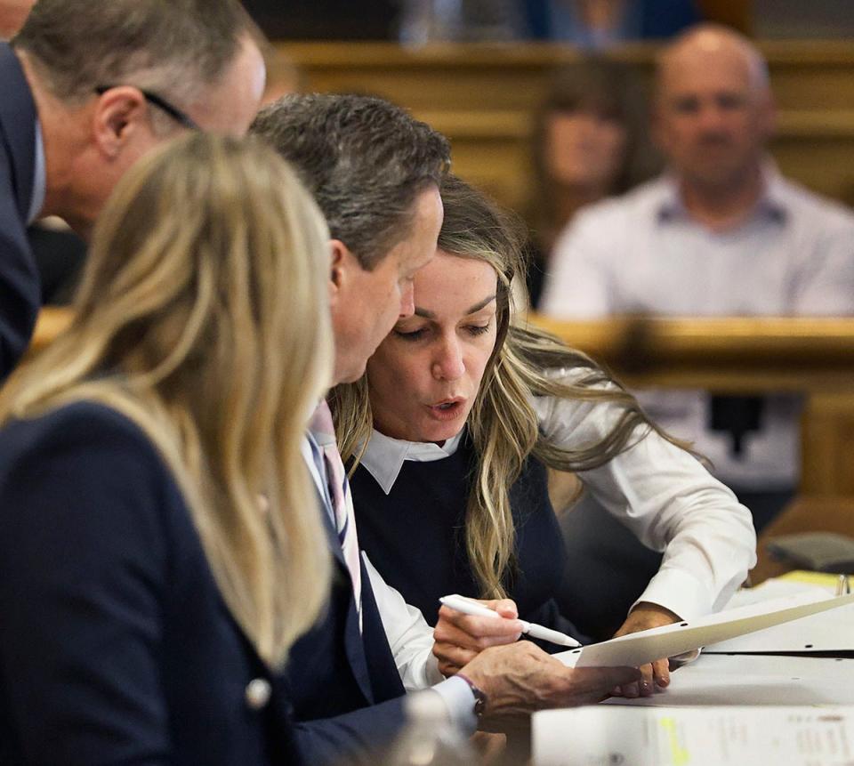 Karen Read talks with her lawyers during her murder trail at Dedham Superior Court on Wednesday (AP)