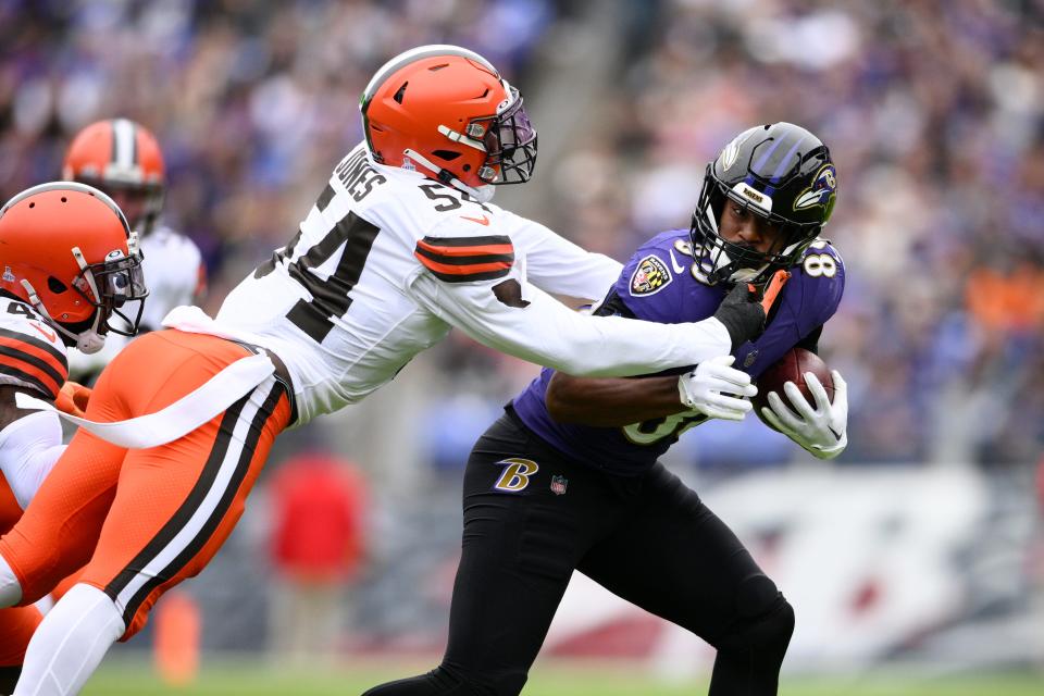 Baltimore Ravens tight end Charlie Kolar (88) tries to escape from Cleveland Browns linebacker Deion Jones (54) after a catch in the first half of an NFL football game, Sunday, Oct. 23, 2022, in Baltimore. (AP Photo/Nick Wass)