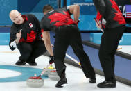 Curling - Pyeongchang 2018 Winter Olympics - Men's Semi-final - Canada v U.S. - Gangneung Curling Center - Gangneung, South Korea - February 22, 2018 - Skip Kevin Koe of Canada watches as lead Ben Hebert of Canada sweeps. REUTERS/Cathal McNaughton