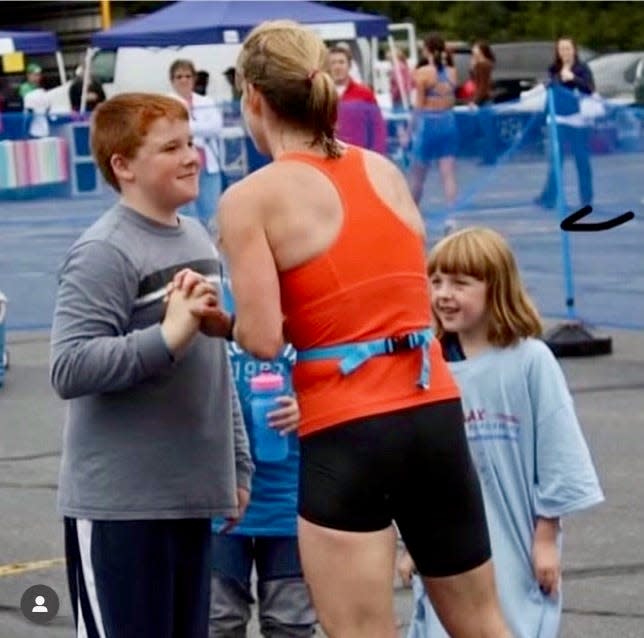 A young Sam Norton greets his mom, Kristen Caisse, with sisters Lucy and Maggie, after a race.