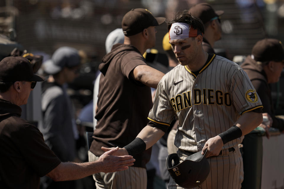 San Diego Padres' Brett Sullivan, right, celebrates with manager Bob Melvin, left, after scoring against the Oakland Athletics during the fourth inning of a baseball game, Saturday, Sept. 16, 2023, in Oakland, Calif. Sullivan scored from third after Juan Soto was walked with the bases loaded. (AP Photo/Godofredo A. Vásquez)