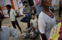 In this photo taken Sunday, Sept. 8, 2019, Indian daily wage laborers and construction workers wait to get hired on the outskirts of New Delhi, India. India's economy, once one of the fastest growing in the world, is braking in a blow to the labor-intensive manufacturing sector. Growth slipped to 5% in the April-June quarter, the slowest pace in six years, and many economists believe that Prime Minister Narendra Modi's signature economic policies are at least partly to blame. (AP Photo/Altaf Qadri)