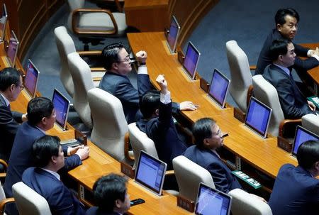 Lawmakers react after impeachment vote on South Korean President Park Geun-hye was passed at the National Assembly in Seoul, South Korea, December 9, 2016. REUTERS/Kim Hong-Ji