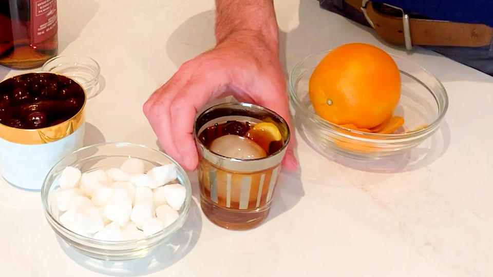 For his Old Fashioned cocktail, Clinton Kelly uses a glug of rye, ice, dark cherry and an orange peel that he gives a quick twist to get the oils out finish the drink.