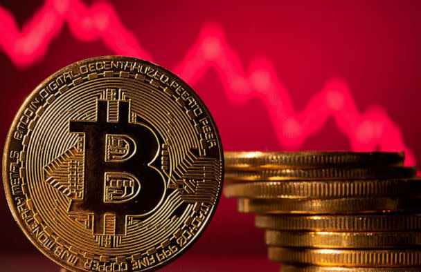 PHOTO: FILE - A representation of bitcoin is seen in front of a stock graph in this illustration taken May 19, 2021. (Dado Ruvic/Reuters, FILE)