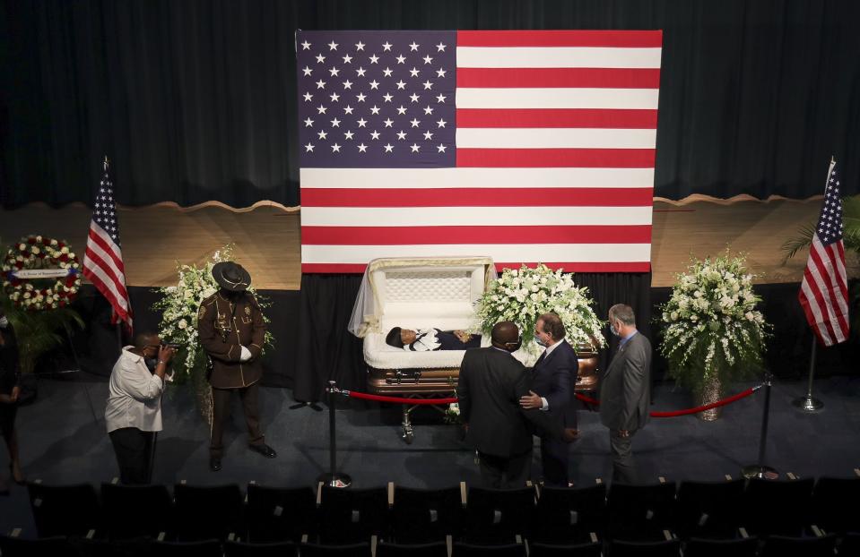 Kendrick Meek, left, receives condolences from Representative Mario Diaz-Balart (R-Fla.), right, and his brother, Lincoln, during the viewing ceremony for Meek's mother, Carrie Meek, Sunday, Dec. 5, 2021, at Booker T. Washington in Miami, Fla. (Carl Juste/Miami Herald via AP)