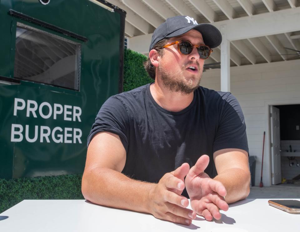 Raf Simpson, co-founder of the Artisan Restaurant Group, talks about the Proper Burger food truck at Vinyl Music Hall’s B Side outdoor venue along Garden Street in downtown Pensacola on Wednesday, July 5, 2023.