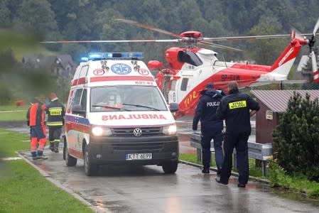 TOPR (Tatra Volunteer Search and Rescue) helicopter and an ambulance are seen as rescuers conduct a rescue operation after a thunderstorm in the Tatra Mountains, in Zakopane