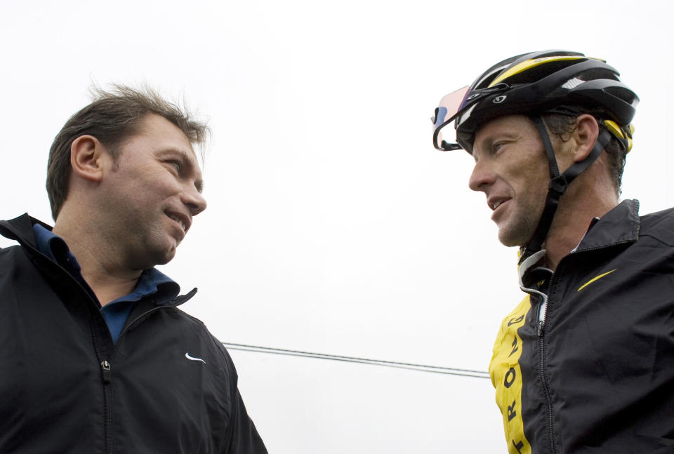 FILE - In this Friday, Dec. 5, 2008, file photo, U.S. cyclist Lance Armstrong, right, talks to Astana team director Johan Bruyneel during a training session near Los Cristianos, on the Canary Island of Tenerife, Spain. In a letter posted on social media Wednesday, Oct. 24, 2018, Bruyneel, Lance Armstrong’s former team manager, said he’s been given a lifetime ban from cycling for his role in a doping program that helped Armstrong win the Tour de France seven times. (AP Photo/Arturo Rodriguez, File)