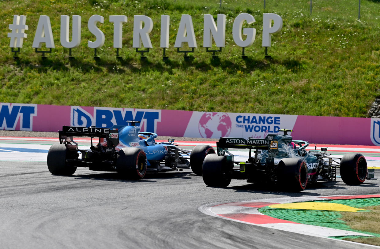 Alpine's Spanish driver Fernando Alonso (L) and Aston Martin's German driver Sebastian Vettel drive during the qualifying session at the Red Bull Ring race track in Spielberg, Austria, on July 3, 2021, ahead of the Formula One Austrian Grand Prix. (Photo by ANDREJ ISAKOVIC / AFP) (Photo by ANDREJ ISAKOVIC/AFP via Getty Images)