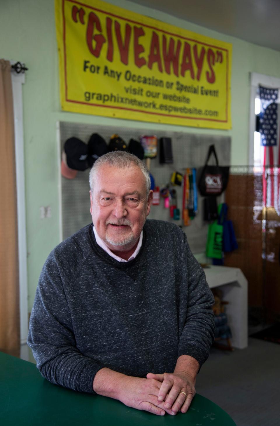 Hal Pixley, owner, stands at the front counter of his Graphix Network shop on March 2, 2023 in Waverly, Ohio.