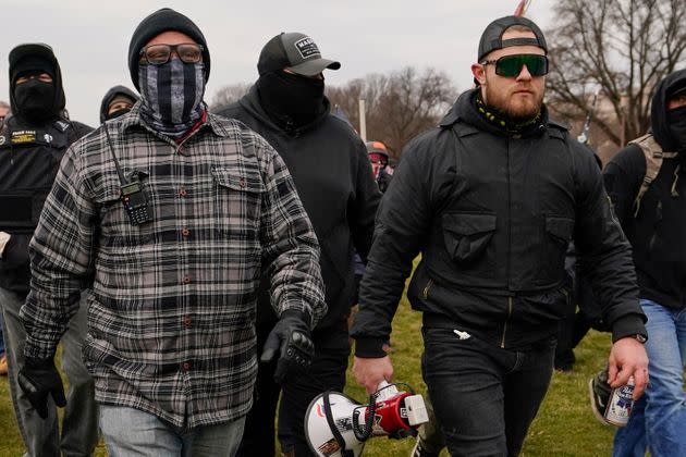 Proud Boys members Joseph Biggs, left, and Ethan Nordean, right with megaphone, walk toward the U.S. Capitol in Washington on Jan. 6, 2021.