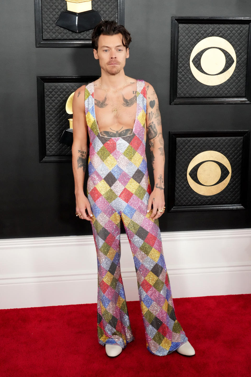 Harry Styles wore a multi-coloured EGONlab jumpsuit on the 2023 Grammys red carpet. (Photo by Jeff Kravitz/FilmMagic)