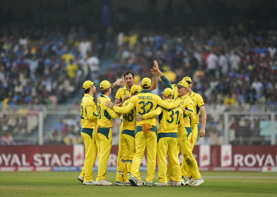 Australia's Mitchell Starc, center, celebrates the wicket of South Africa's Aiden Markram with his teammates during the ICC Men's Cricket World Cup second semifinal match between Australia and South Africa in Kolkata, India, Thursday, Nov.16, 2023. (AP Photo/Aijaz Rahi)
