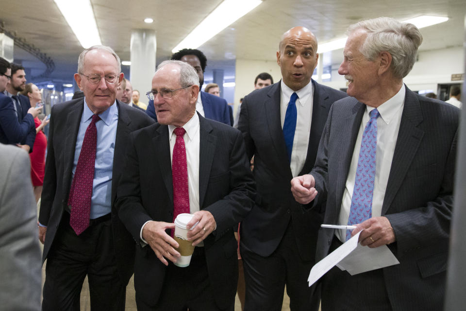 Sen. Lamar Alexander, R-Tenn., left, Sen. Jim Risch, R-Idaho, Sen. Cory Booker, D-N.J., and Sen. Angus King, I-Maine, walk to a vote on Capitol Hill, Thursday, June 27, 2019 in Washington. (AP Photo/Alex Brandon)