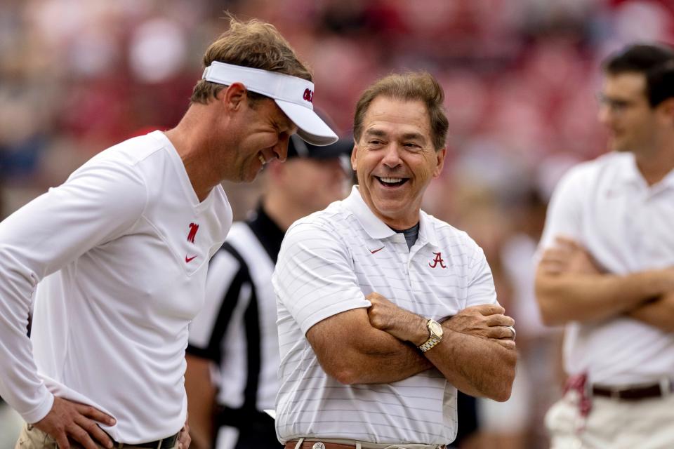 Mississippi head coach Lane Kiffin, left, and Alabama head coach Nick Saban share a laugh as they meet in the middle of the field before an NCAA college football game, Saturday, Oct. 2, 2021, in Tuscaloosa, Ala. (AP Photo/Vasha Hunt)