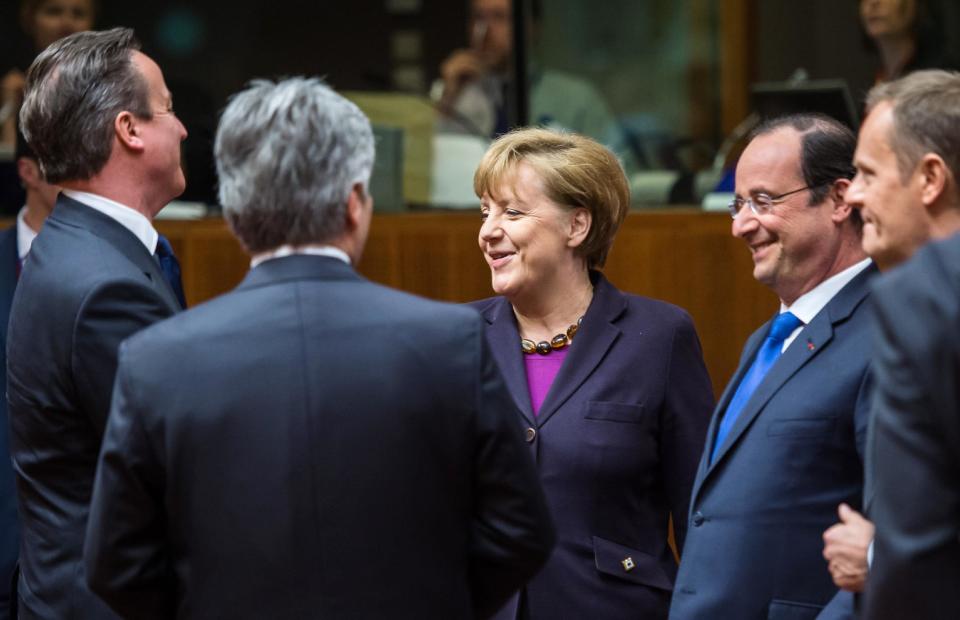 From left, British Prime Minister David Cameron, Austrian Chancellor Werner Faymann, German Chancellor Angela Merkel, French President Francois Hollande and Polish Prime Minister Donald Tusk speak with each other during a round table meeting an EU summit in Brussels on Thursday, March 20, 2014. The EU Commission president wants a two-day summit of European Union leaders to center on boosting the fledgling government in Kiev rather than focus exclusively on sanctions against Russia over its annexation of Ukraine’s Crimea peninsula. (AP Photo/Geert Vanden Wijngaert)