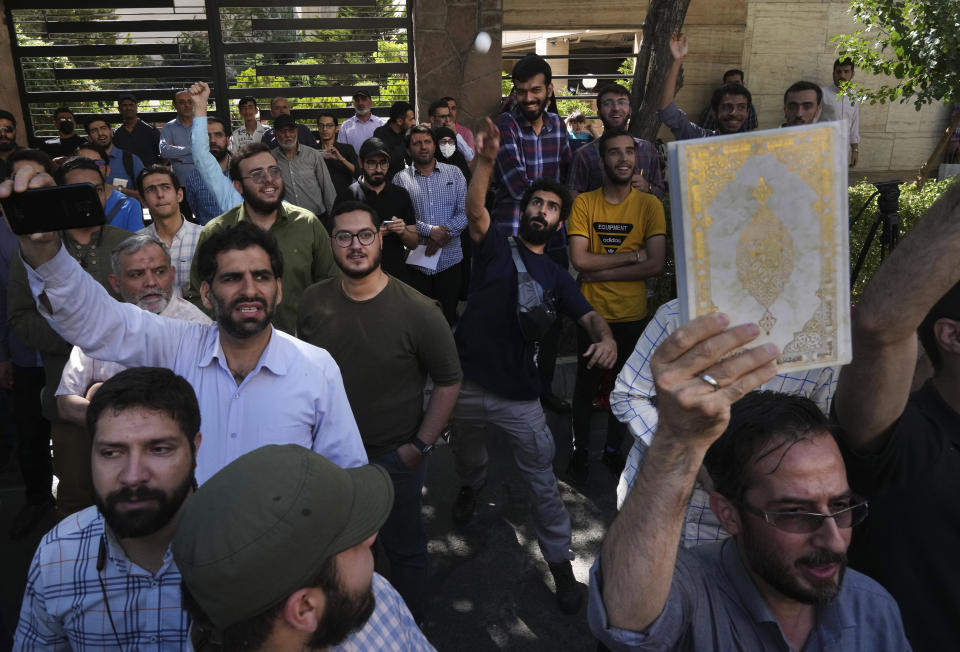 A demonstrator throws an egg at the Swedish Embassy building in Tehran, Iran, during a protest of the burning of a Quran in Sweden, Friday, June 30, 2023. On Wednesday, a man who identified himself in Swedish media as a refugee from Iraq burned a Quran outside a mosque in central Stockholm. (AP Photo/Vahid Salemi)