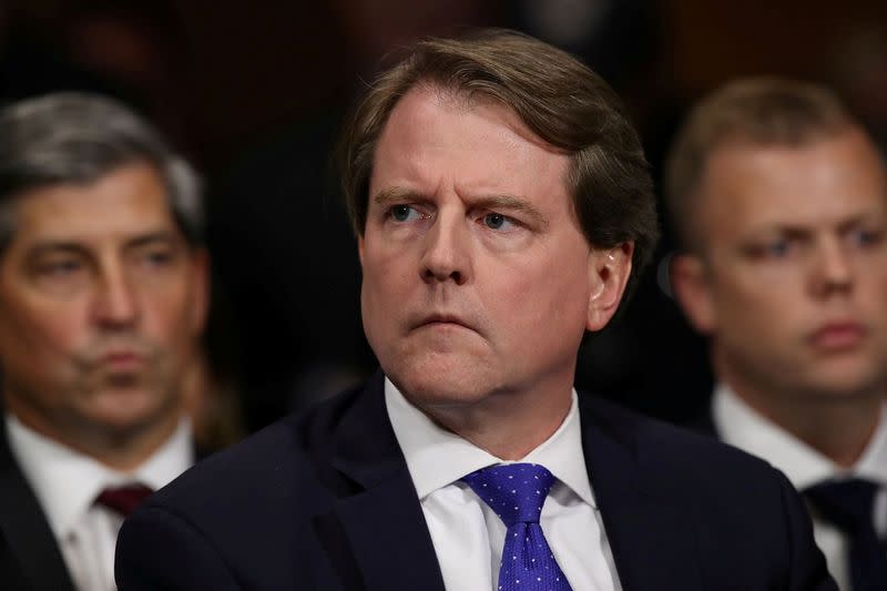 FILE PHOTO: White House Counsel Don McGahn listens to Judge Brett Kavanaugh as he testifies before the Senate Judiciary Committee during his Supreme Court confirmation hearing in the Dirksen Senate Office Building on Capitol Hill