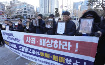 Family members of forced labor victims during the Japan's colonial period arrive at the Supreme Court in Seoul, South Korea, Thursday, Dec. 21, 2023. The sign reads "Mitsubishi Heavy Industries should compensate and apologize." South Korea’s top court ordered two Japanese companies to financially compensate more of their wartime Korean workers for forced labor, as it sided Thursday with its contentious 2018 verdicts that caused a huge setback in relations between the two countries.(AP Photo/Ahn Young-joon)