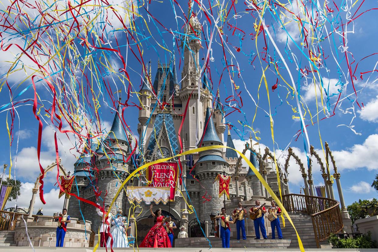 disney world's magic kingdom castle with streamers in the air to celebrate the arrival of princess elena