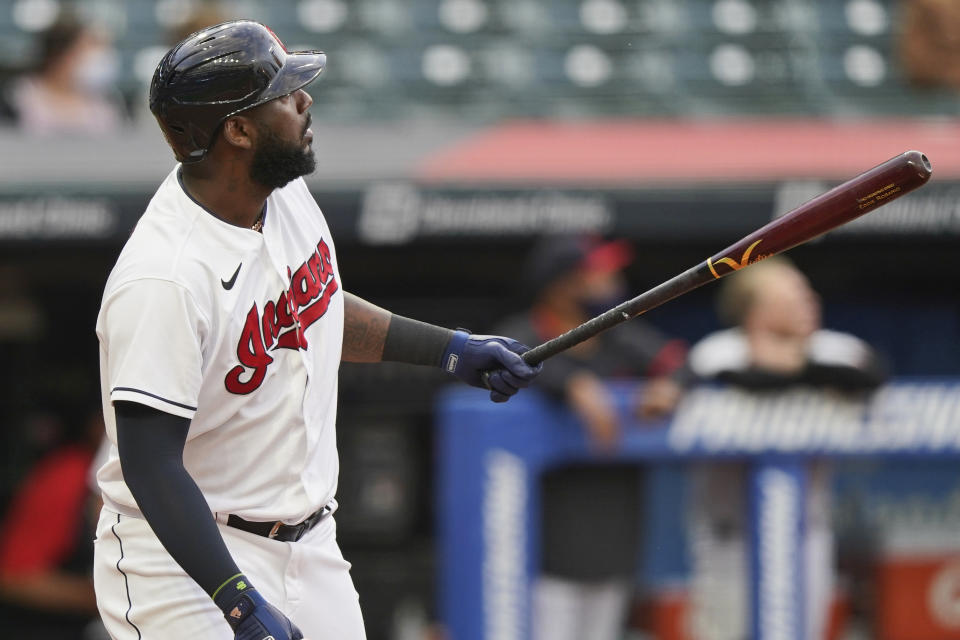 Cleveland Indians' Franmil Reyes watches his two-run home run off Detroit Tigers starting pitcher Derek Holland during the first inning of a baseball game Friday, April 9, 2021, in Cleveland. (AP Photo/Tony Dejak)