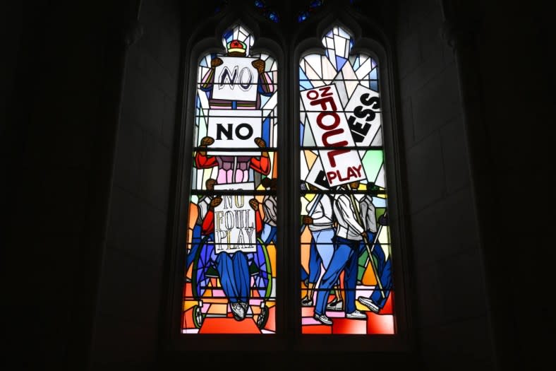 Light shines through new stained-glass windows with a theme of racial justice during an unveiling and dedication ceremony at the Washington National Cathedral for the windows on Saturday, Sept. 23, 2023, in Washington. (AP Photo/Nick Wass)