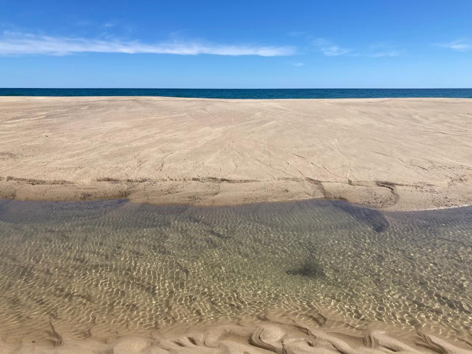 A tide pool and the big blue Atlantic Ocean in Wellfleet.