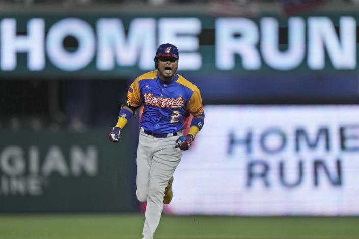 Venezuela's Luis Arraez celebrates as he rounds second base after he hit a home run scoring Jose Altuve during the first inning of a World Baseball Classic game against the U.S., Saturday, March 18, 2023, in Miami. (AP Photo/Wilfredo Lee)