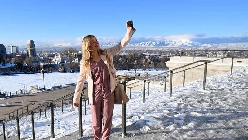 Caroline Gleich holds up a GoPro camera on the front steps of the Capitol in Salt Lake City after filing as a U.S. Senate candidate on Monday, Jan. 8, 2024.