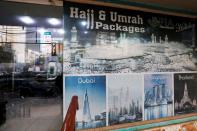 A sign promotes airline's Haj and Umrah packages outside a ticketing office in Karachi