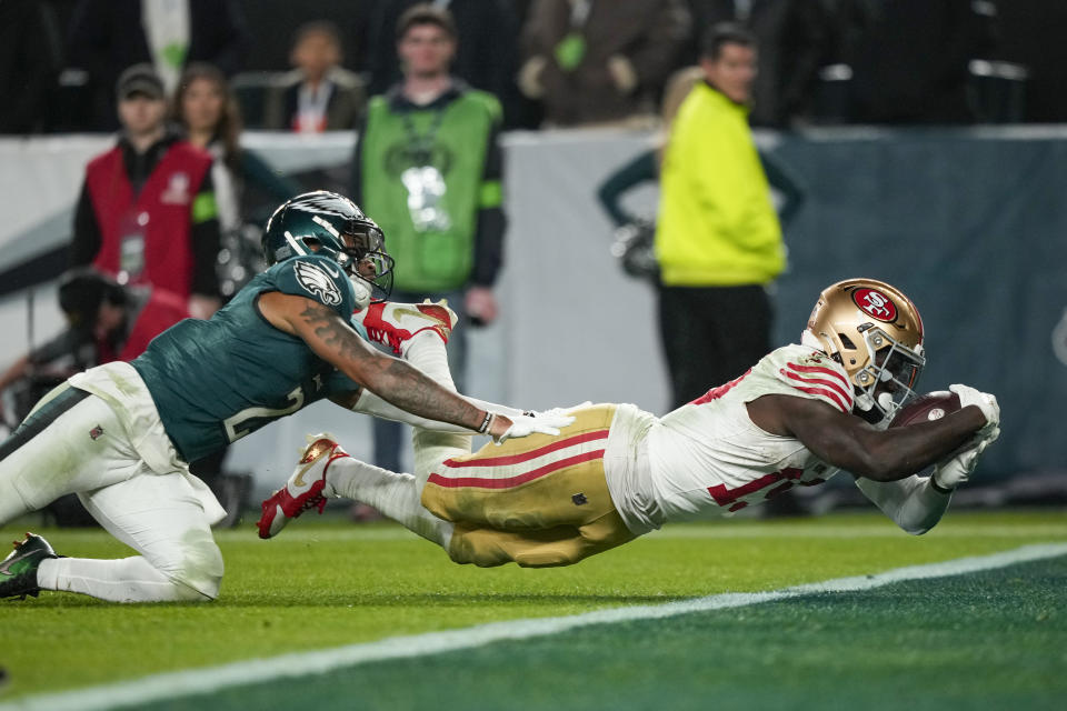 San Francisco 49ers wide receiver Deebo Samuel, right, dives in for a touchdown as Philadelphia Eagles cornerback Darius Slay tries to stop him during the second half of an NFL football game, Sunday, Dec. 3, 2023, in Philadelphia. (AP Photo/Matt Slocum)