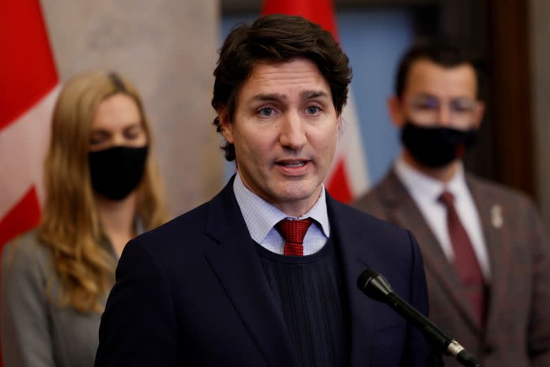 Canada's Prime Minister Justin Trudeau, with Minister of Sport Pascale St-Onge and Parliamentary Secretary to the Minister of Sport Adam van Koeverden, speaks during a press conference on Parliament Hill in Ottawa