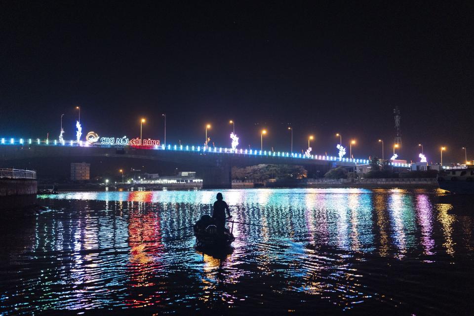 Nguyen Thi Thuy, a vendor who sells steamed buns at a floating market, pauses her paddle briefly on her way to the market before sunrise in Can Tho, Vietnam, Wednesday, Jan. 17, 2024. (AP Photo/Jae C. Hong)