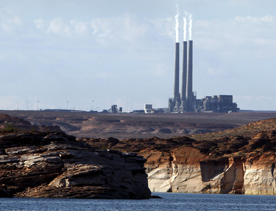 FILE - In this Sept. 4, 2011 file photo shows the main plant facility at the Navajo Generating Station, from Lake Powell, in Page, Ariz. Two environmental groups are asking a federal court to set a deadline for the U.S. Environmental Protection Agency to issue mandates for pollution controls at two power plants, including Four Corners, on the Navajo Nation.(AP Photo/Ross D. Franklin, file)