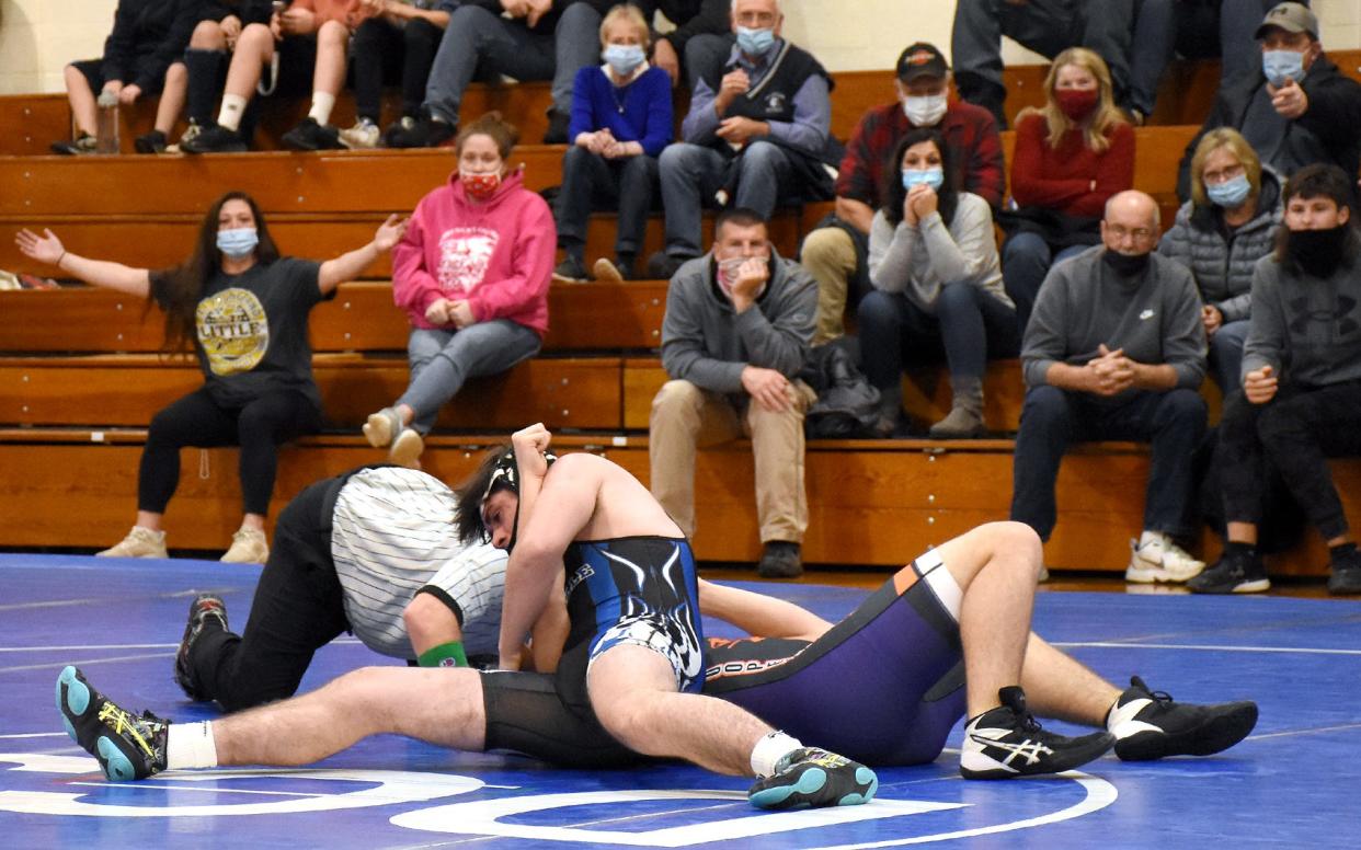 Dolgeville Blue Devil Cameron Jackson works to force the other shoulder of Cooperstown/Milford's Noah Lapointe to the mat for a pin in Tuesday's 172-pound bout in Dolgeville.