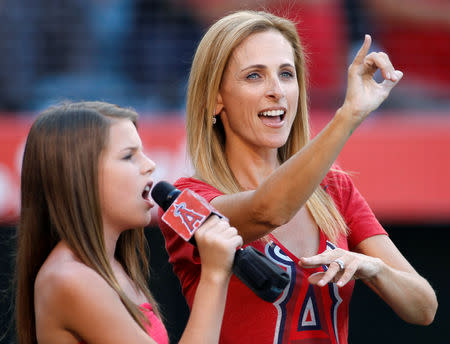 FILE PHOTO: Actress Marlee Matlin (R) performs the national anthem with sign language as Eve Devault sings it before the MLB American League baseball game between the Texas Rangers and Los Angeles Angels in Anaheim, California, U.S., July 22, 2012. REUTERS/Danny Moloshok/File Photo