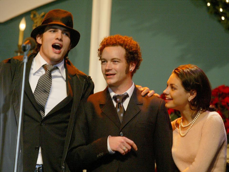 Danny Masterson, Mila Kunis, and Ashton Kutcher at the Church of Scientology's 11th Annual Christmas Stories Fundraiser in 2003.