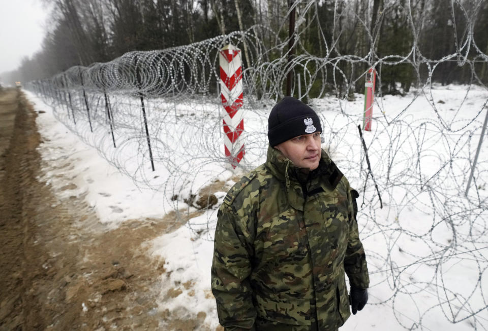 A military person patrols a the start of the work on the first part of a 180 kilometers (115 miles) and 5.5 meter (18ft)-high metal wall intended to block migrants from Belarus crossing illegally into EU territory, in Tolcze, near Kuznica, Poland, Jan. 27, 2022. A year after migrants started crossing into the European Union from Belarus to Poland, Polish authorities are planning to announce Thursday that a 5.5-meter-tall steel wall along its border to the north with Belarus is set to be completed. (AP Photo/Czarek Sokolowski, File)