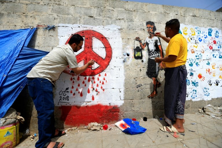 Yemeni artists paint a pro-peace graffiti on a wall in the capital Sanaa on August 16, 2018 as they call for peace and tolerance and rejecting the ongoing conflict in the Arab world's most impoverished country