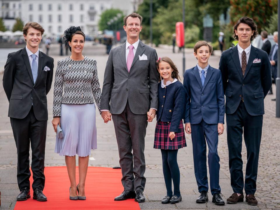 Prince Joachim, Princess Marie, and their four children stand beside a boat.