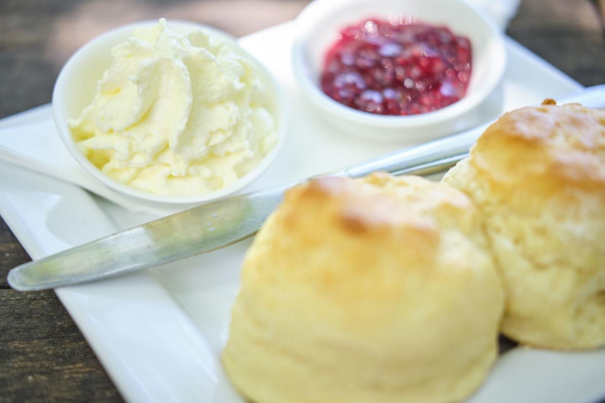 clotted cream next to scones and jam