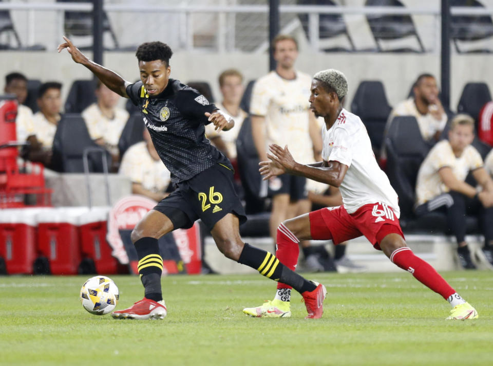 Columbus Crew defender Saad Abdul-Salaam left, controls the ball in front of New York Red Bulls defender Kyle Duncan during the first half of an MLS soccer match in Columbus, Ohio, Tuesday, Sept. 14, 2021. (AP Photo/Paul Vernon)