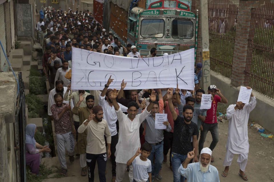 Kashmiri Muslims shout pro-freedom slogans during a demonstration after Friday prayers amid curfew like restrictions in Srinagar, India, Friday, Aug. 16, 2019. India's government assured the Supreme Court on Friday that the situation in disputed Kashmir is being reviewed daily and unprecedented security restrictions will be removed over the next few days, an attorney said after the court heard challenges to India's moves.(AP Photo/Dar Yasin)