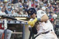 Milwaukee Brewers' Luis Uria is hit by a pitch during the seventh inning of a baseball game against the Cincinnati Reds Sunday, Aug. 7, 2022, in Milwaukee. (AP Photo/Morry Gash)