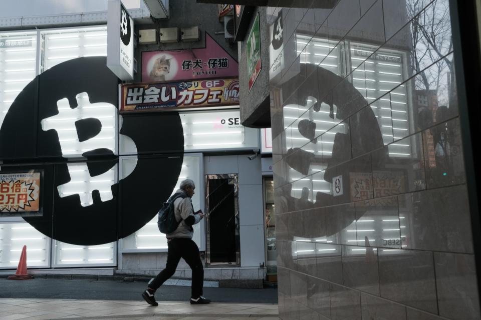 A pedestrian walks past a Sakura Bitcoin Exchange Inc. store in the Shibuya district of Tokyo on Friday, Feb. 25, 2022. Cryptocurrency exchanges are still trying to figure out how to deal with western sanctions against Russia after its invasion of Ukraine. Photographer: Soichiro Koriyama/Bloomberg