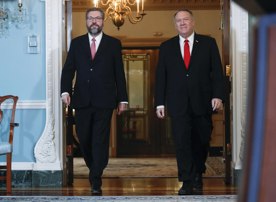 Secretary of State Mike Pompeo, right, and Brazilian Foreign Minister Ernesto Araujo, left, walk out to deliver remarks to members of the media at the Department of State in Washington, Friday, Sept. 13, 2019. (AP Photo/Pablo Martinez Monsivais)